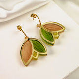 Gold Tulip Huggie Earrings with a leaf design, featuring cream, green, and taupe enamel sections. These lightweight, handcrafted earrings are displayed on a white surface with soft, white satin in the background.